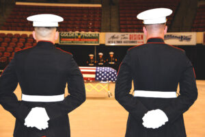 Flanked by members of Police Company Delta of the U.S. Marine Corps, Sen. Conrad Burns' casket, draped in a U.S. flag, awaits the family processional Friday morning at MetraPark. (Judy Killen photo)