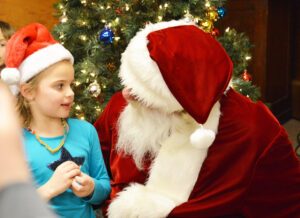 Payton Christman chats with Santa Claus on Friday at the Worden VFW during the Christmas Stroll. Please see more photos from the Worden Christmas Stroll. (Jonathan McNiven photo)
