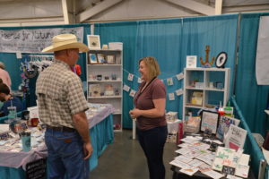 Small business owner Anna Meeks, right, visits with Montana US Congressman Greg Gianforte about her business while he visited MontanaFair on Monday August 13, 2018. (Photo by Jonathan McNiven)