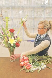 A and E Florist and small business owner Sheri Murphy, 38, prepares an arrangement of flowers Monday afternoon in preparation for a customer. (Photo by Jonathan McNiven)