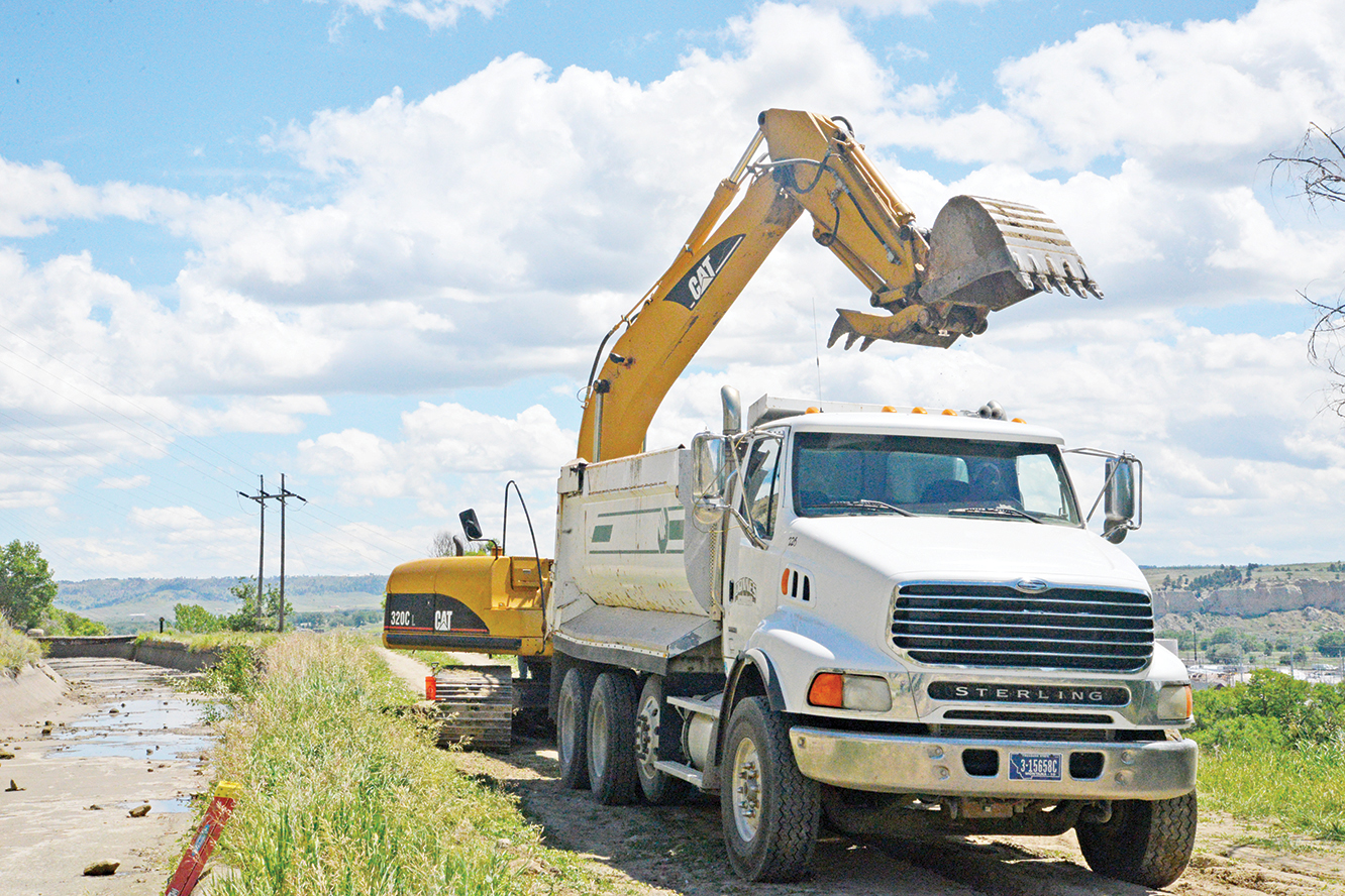 Donnes Construction dump truck is being loaded with dirt from test holes that are being dug to assess the water seepage from the canal in Billings to residents below.(Jonathan McNiven Photo)