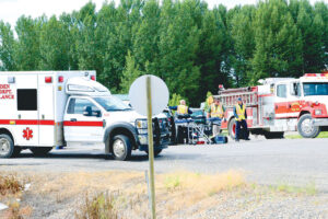 Emergency Medical Services Personnel are reponding and attending to multiple injuries at a crash along hwy 312 and road 8 in Worden. (Jonathan McNiven Photo)
