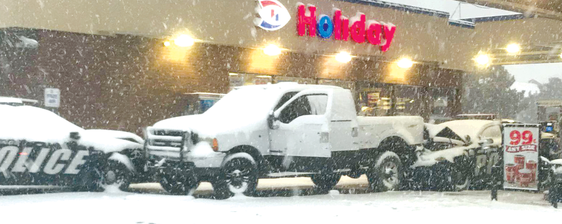 The pickup driven by the suspect sits between two rammed police cruisers in the parking lot of the Holiday gas station on the corner of N. 27th St. and 6th Ave. N. (Photo courtesy of KULR8)