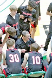 Huntley Project Head Coach, Randy Robinson directing playersat the Divisional Basketball tournament. photo -Lori Durst Ellis