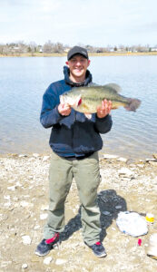 Brandon Wright displays his record large mouth bass after pulling it from the water at Lake Elmo in Billings Heights Saturday. (courtesy photo)