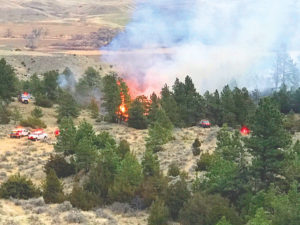 Multiple agencies and fire departments start to contain the Easter Day fire that originally started from a controlled burn in in Huntley. (Jonathan McNiven photo)