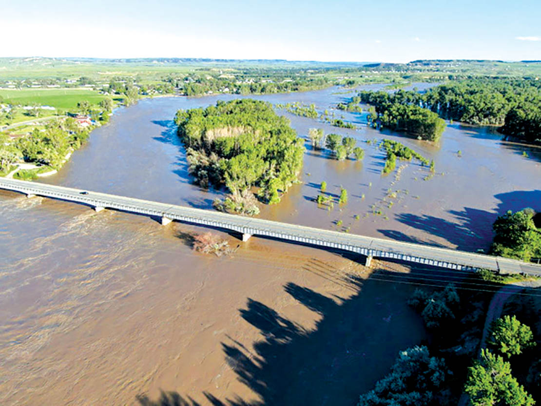 Historic flood waters rushed over the Huntley Diversion Dam Wednesday afternoon June 16, 2022, showing a 6-8 foot drop after the water flowed over the diversion dam. (Drone Image by Jonathan McNiven)
