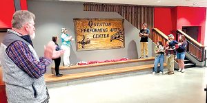 Q Staton’s father, David Staton stands the left, watching as the Staton family unveil the plaque that will henceforth designate the Q Staton Performing Arts Center.